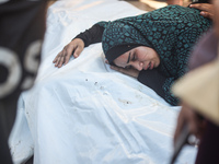 Palestinians are mourning by the bodies of relatives killed in Israeli bombardment on Nuseirat in the central Gaza Strip at Al-Aqsa Martyrs...