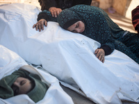 Palestinians are mourning by the bodies of relatives killed in Israeli bombardment on Nuseirat in the central Gaza Strip at Al-Aqsa Martyrs...