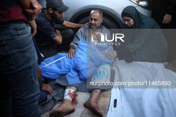 Palestinians are mourning by the bodies of relatives killed in Israeli bombardment on Nuseirat in the central Gaza Strip at Al-Aqsa Martyrs...