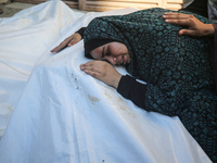 Palestinians are mourning by the bodies of relatives killed in Israeli bombardment on Nuseirat in the central Gaza Strip at Al-Aqsa Martyrs...