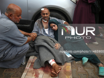 Palestinians are mourning by the bodies of relatives killed in Israeli bombardment on Nuseirat in the central Gaza Strip at Al-Aqsa Martyrs...