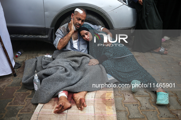 Palestinians are mourning by the bodies of relatives killed in Israeli bombardment on Nuseirat in the central Gaza Strip at Al-Aqsa Martyrs...