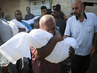 Palestinians are mourning by the bodies of relatives killed in Israeli bombardment on Nuseirat in the central Gaza Strip at Al-Aqsa Martyrs...