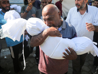 Palestinians are mourning by the bodies of relatives killed in Israeli bombardment on Nuseirat in the central Gaza Strip at Al-Aqsa Martyrs...