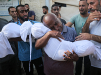 Palestinians are mourning by the bodies of relatives killed in Israeli bombardment on Nuseirat in the central Gaza Strip at Al-Aqsa Martyrs...