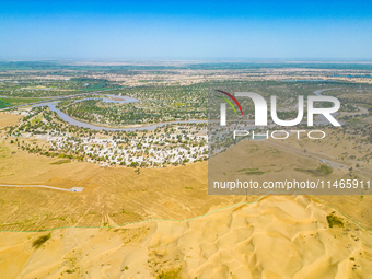 The meandering Tarim River is nourishing vegetation along its banks in the Weili section of the middle and lower reaches of the Tarim River...