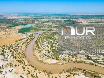 The meandering Tarim River is nourishing vegetation along its banks in the Weili section of the middle and lower reaches of the Tarim River...