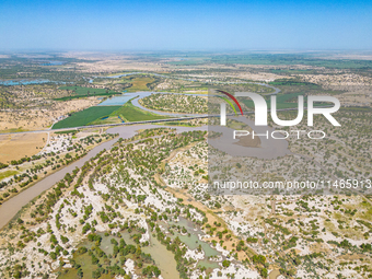 The meandering Tarim River is nourishing vegetation along its banks in the Weili section of the middle and lower reaches of the Tarim River...