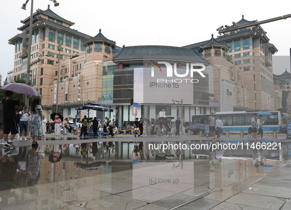 A photo is showing the Wangfujing Pedestrian Street after rain in Beijing, China, on August 10, 2024. 