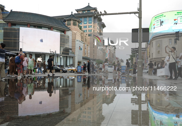 A photo is showing the Wangfujing Pedestrian Street after rain in Beijing, China, on August 10, 2024. 