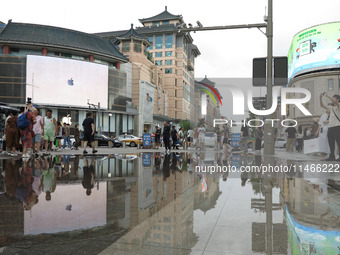 A photo is showing the Wangfujing Pedestrian Street after rain in Beijing, China, on August 10, 2024. (