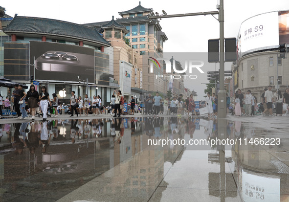 A photo is showing the Wangfujing Pedestrian Street after rain in Beijing, China, on August 10, 2024. 