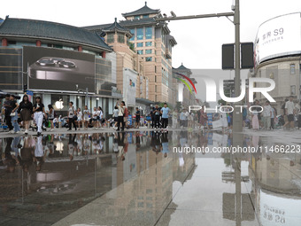 A photo is showing the Wangfujing Pedestrian Street after rain in Beijing, China, on August 10, 2024. (