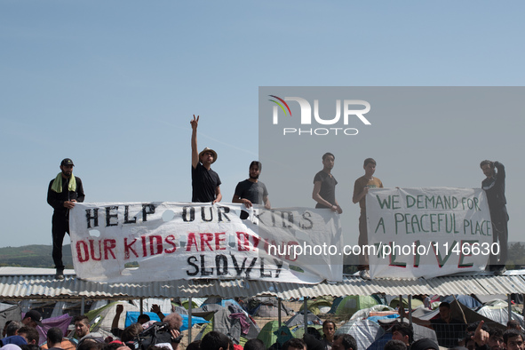 Men holding panflets during a demonstration in Idomeni on April 6, 2016.. A plan to send back migrants from Greece to Turkey sparked demonst...