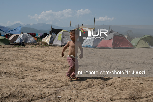 Hussein, a 3 years old Syrian, running back after a short cut on April 6, 2016.. A plan to send back migrants from Greece to Turkey sparked...