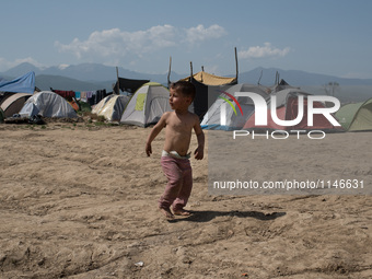 Hussein, a 3 years old Syrian, running back after a short cut on April 6, 2016.. A plan to send back migrants from Greece to Turkey sparked...