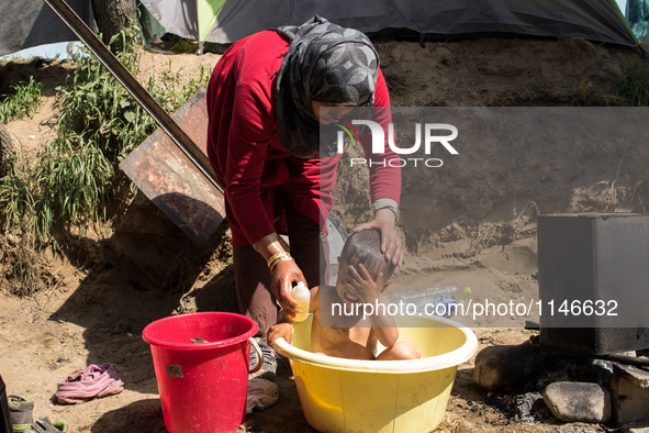 Hussein, a 3 years old Syrian, is getting a bath in Idomeni on April 6, 2016.. A plan to send back migrants from Greece to Turkey sparked de...