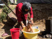 Hussein, a 3 years old Syrian, is getting a bath in Idomeni on April 6, 2016.. A plan to send back migrants from Greece to Turkey sparked de...