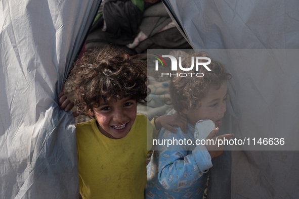 Kids going outside their tent. In Idomeni camp on April 6, 2016.. A plan to send back migrants from Greece to Turkey sparked demonstrations...