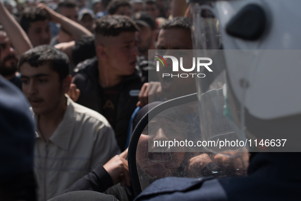 Lady shout to a police during a demonstration in Idomeni on April 6, 2016.. A plan to send back migrants from Greece to Turkey sparked demon...