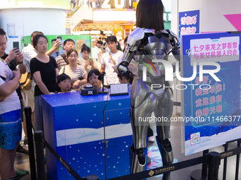 Humanoid robot Xiao Qi is having a dialogue with visitors during the event of Qixi, a traditional Chinese Valentine festival, at Long Zhi Mo...