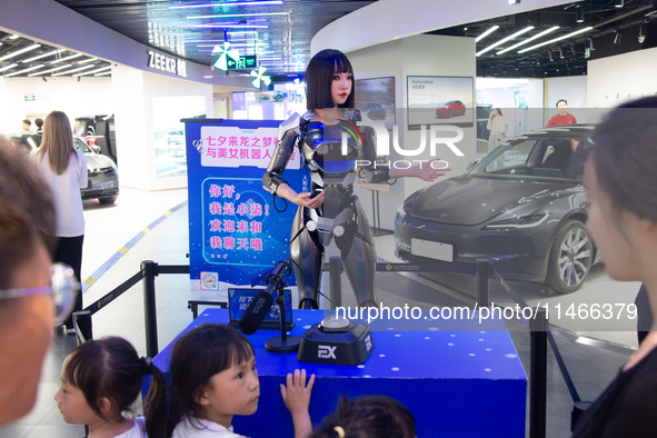 Humanoid robot Xiao Qi is having a dialogue with visitors during the event of Qixi, a traditional Chinese Valentine festival, at Long Zhi Mo...