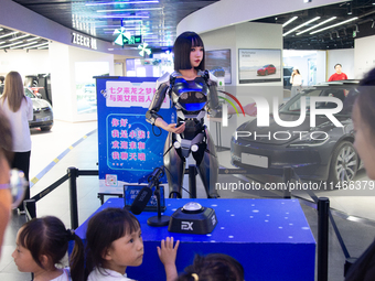 Humanoid robot Xiao Qi is having a dialogue with visitors during the event of Qixi, a traditional Chinese Valentine festival, at Long Zhi Mo...