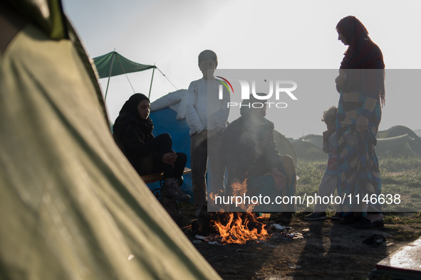 Family warming up early in the morning in Idomeni camp on April 6, 2016.. A plan to send back migrants from Greece to Turkey sparked demonst...