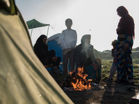 Family warming up early in the morning in Idomeni camp on April 6, 2016.. A plan to send back migrants from Greece to Turkey sparked demonst...