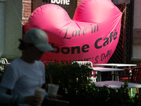 A large heart balloon is being placed at an outdoor cafe during Qixi, a Chinese traditional Valentine, in Shanghai, China, on August 10, 202...