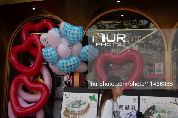 Large heart balloons are being placed at an outdoor cafe during Qixi, a Chinese traditional Valentine, in Shanghai, China, on August 10, 202...