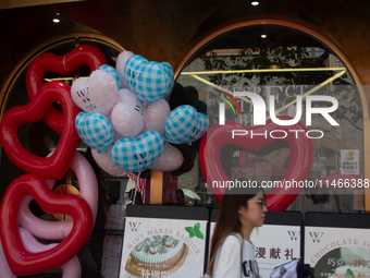 Large heart balloons are being placed at an outdoor cafe during Qixi, a Chinese traditional Valentine, in Shanghai, China, on August 10, 202...