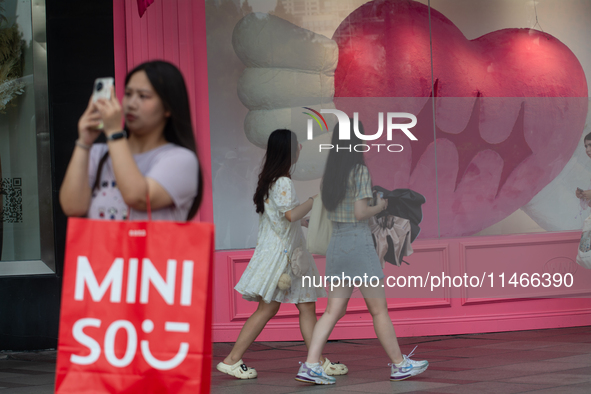 Large heart balloons are being placed in front of a store during Qixi, a Chinese traditional Valentine, in Shanghai, China, on August 10, 20...