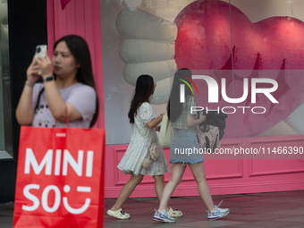 Large heart balloons are being placed in front of a store during Qixi, a Chinese traditional Valentine, in Shanghai, China, on August 10, 20...