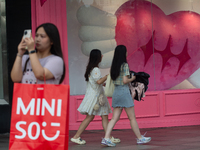 Large heart balloons are being placed in front of a store during Qixi, a Chinese traditional Valentine, in Shanghai, China, on August 10, 20...