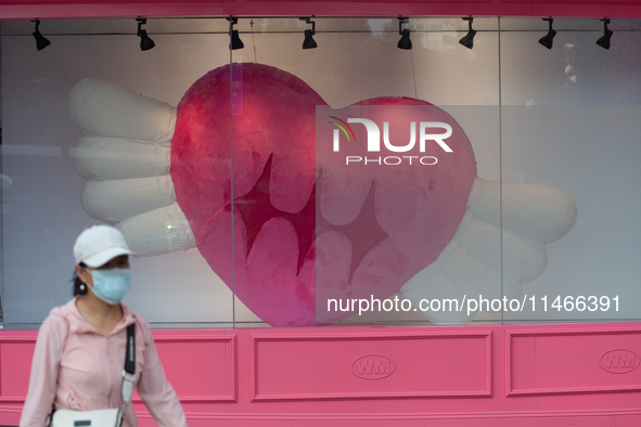 Large heart balloons are being placed in front of a store during Qixi, a Chinese traditional Valentine, in Shanghai, China, on August 10, 20...