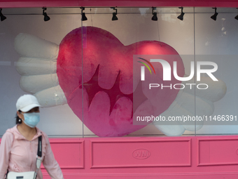 Large heart balloons are being placed in front of a store during Qixi, a Chinese traditional Valentine, in Shanghai, China, on August 10, 20...