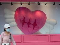 Large heart balloons are being placed in front of a store during Qixi, a Chinese traditional Valentine, in Shanghai, China, on August 10, 20...