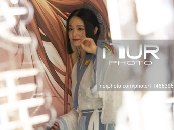 A woman is wearing traditional Chinese Han clothing at Yu Garden during Qixi, a traditional Chinese Valentine's Day, in Shanghai, China, on...