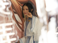 A woman is wearing traditional Chinese Han clothing at Yu Garden during Qixi, a traditional Chinese Valentine's Day, in Shanghai, China, on...