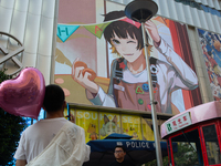 A young man is holding a heart balloon on Nanjing Road during Qixi, a Chinese traditional Valentine, in Shanghai, China, on August 10, 2024....