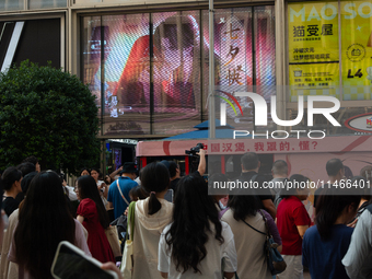 A large screen displaying ''Happy Qixi'' is being seen on Nanjing Road during Qixi, a Chinese traditional Valentine, in Shanghai, China, on...