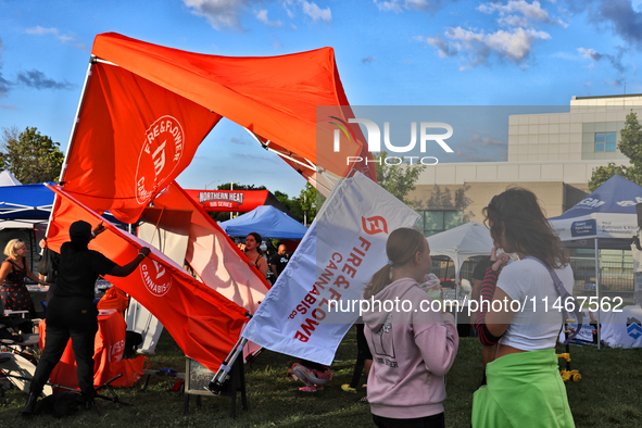 A tent from a cannabis vendor is almost blowing away during a festival as strong winds are sweeping across the city of Toronto, Ontario, Can...