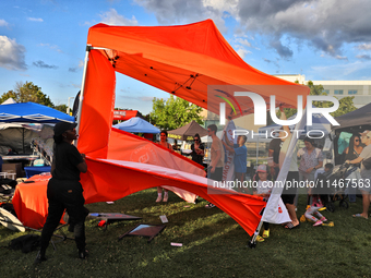 A tent from a cannabis vendor is almost blowing away during a festival as strong winds are sweeping across the city of Toronto, Ontario, Can...