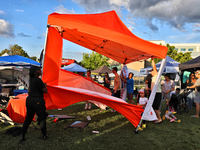 A tent from a cannabis vendor is almost blowing away during a festival as strong winds are sweeping across the city of Toronto, Ontario, Can...