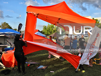 A tent from a cannabis vendor is almost blowing away during a festival as strong winds are sweeping across the city of Toronto, Ontario, Can...