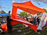 A tent from a cannabis vendor is almost blowing away during a festival as strong winds are sweeping across the city of Toronto, Ontario, Can...