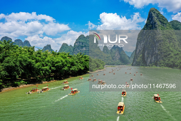 Tourists are visiting the Li River on a raft in Guilin, China, on August 8, 2024. 