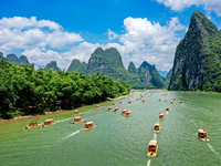 Tourists are visiting the Li River on a raft in Guilin, China, on August 8, 2024. (