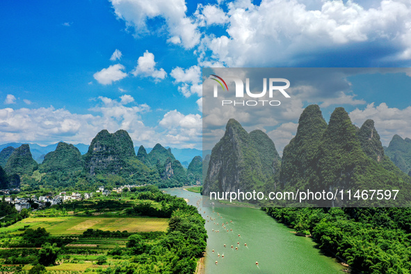 Tourists are visiting the Li River on a raft in Guilin, China, on August 8, 2024. 